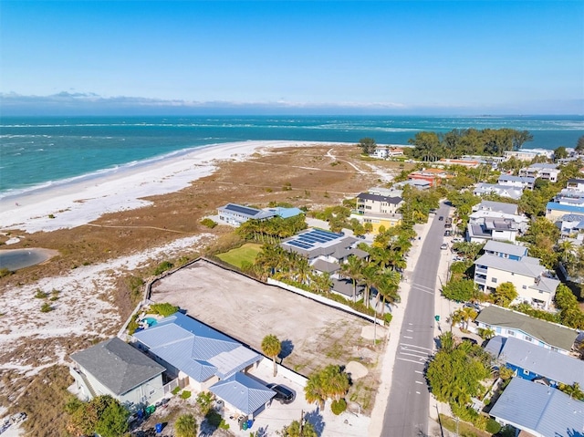 drone / aerial view featuring a view of the beach and a water view