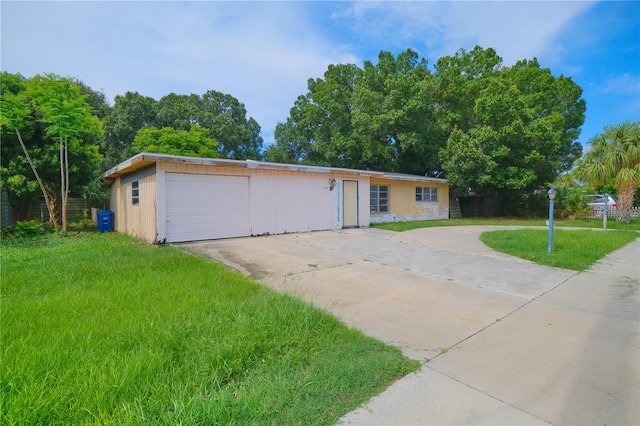 single story home with a garage and a front yard