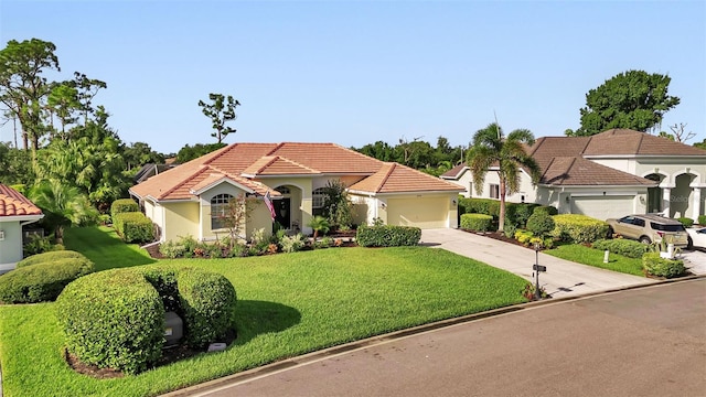 mediterranean / spanish-style house featuring a garage, concrete driveway, a tiled roof, a front yard, and stucco siding