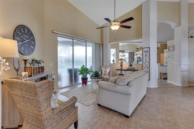 living room with high vaulted ceiling, ceiling fan, and light tile patterned floors