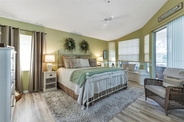 bedroom with ceiling fan, vaulted ceiling, and light hardwood / wood-style floors