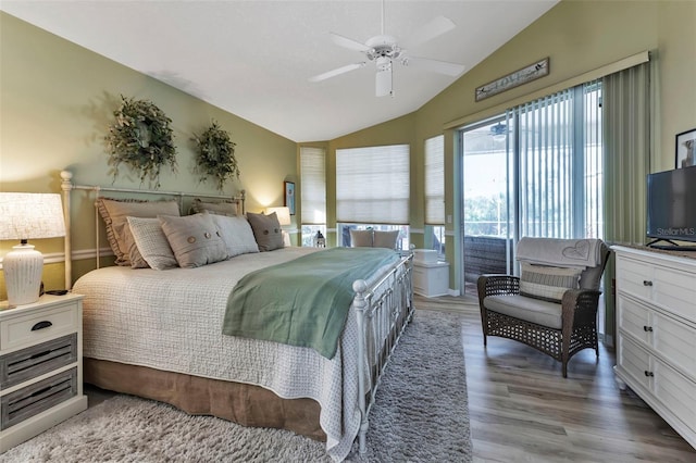 bedroom with ceiling fan, vaulted ceiling, and hardwood / wood-style floors