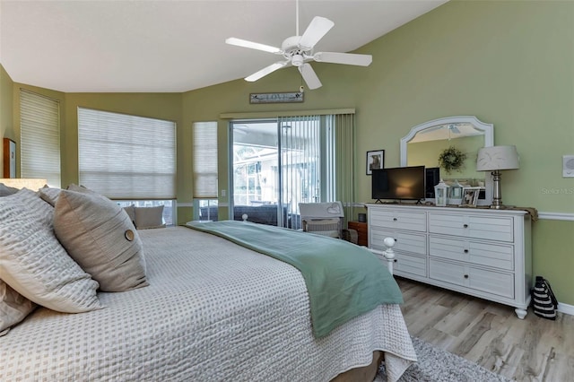 bedroom with light wood-type flooring, vaulted ceiling, and ceiling fan