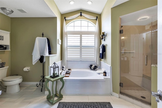 bathroom featuring toilet, tile patterned flooring, vaulted ceiling, separate shower and tub, and a textured ceiling