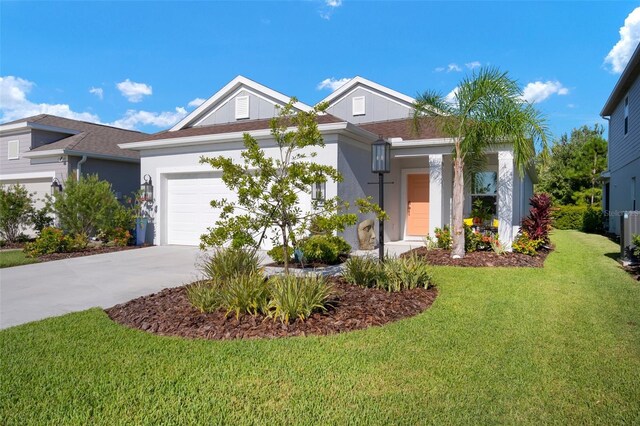 view of front of house featuring a garage and a front lawn