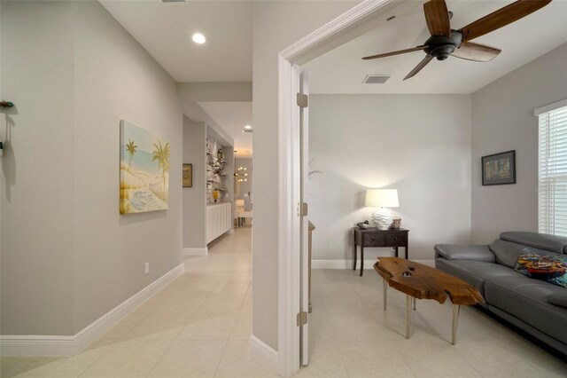 living room featuring light tile patterned flooring and ceiling fan