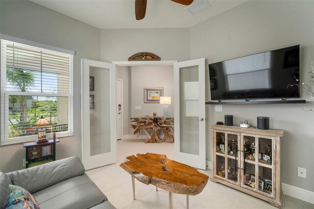 tiled living room with lofted ceiling and ceiling fan