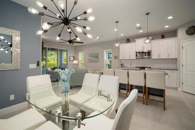 dining space featuring ceiling fan and light tile patterned floors