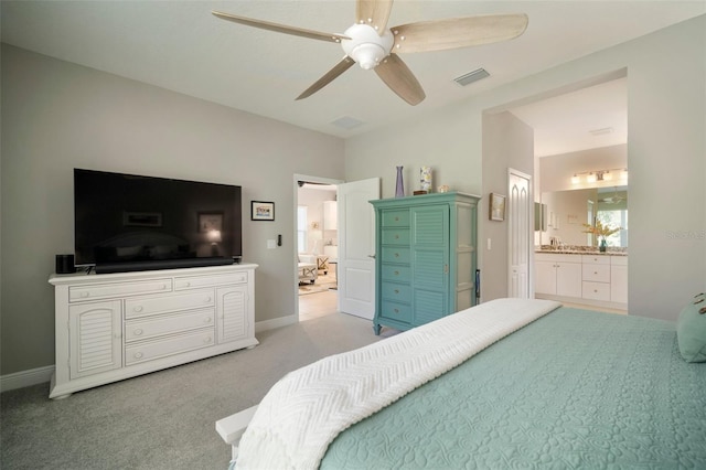 carpeted bedroom featuring connected bathroom and ceiling fan