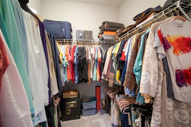 walk in closet featuring carpet flooring