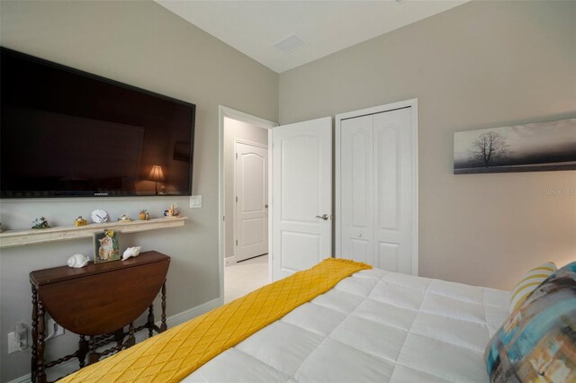 bedroom with light colored carpet and a closet