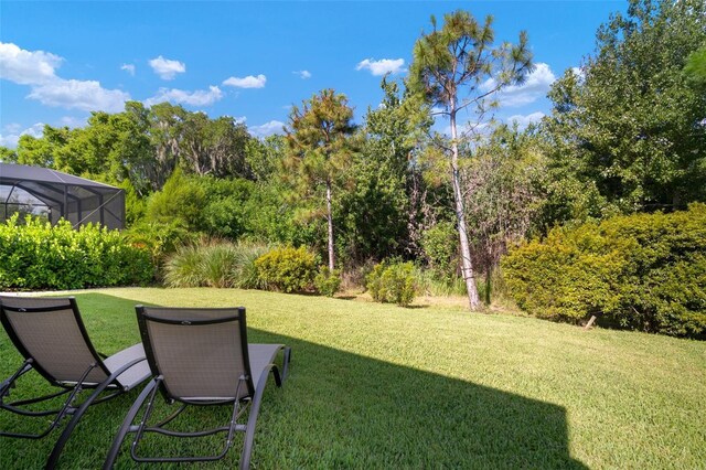 view of yard featuring a lanai