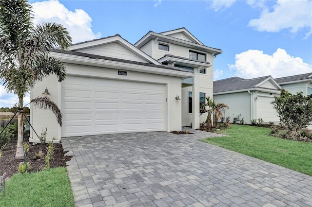 view of front of home with a garage and a front lawn