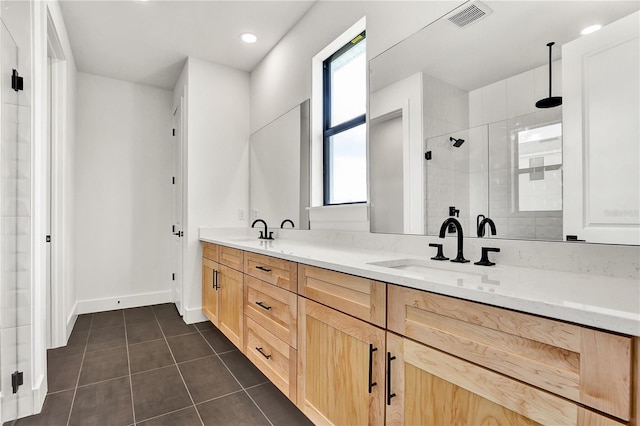 bathroom featuring tile patterned floors, vanity, and walk in shower