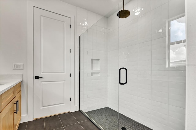 bathroom with vanity, tile patterned floors, and a shower with shower door