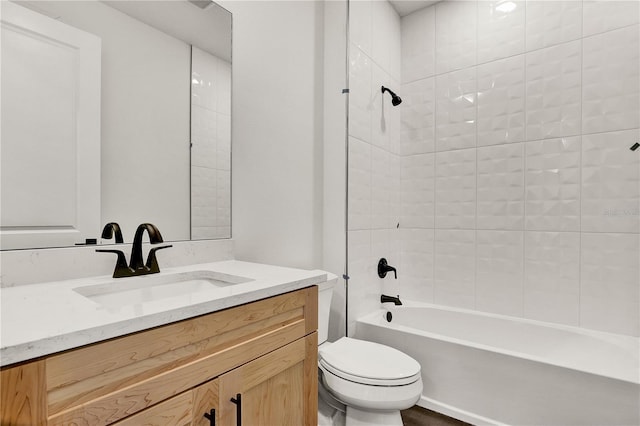 full bathroom with vanity, tiled shower / bath combo, and toilet