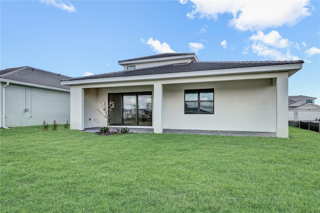 rear view of house with a lawn