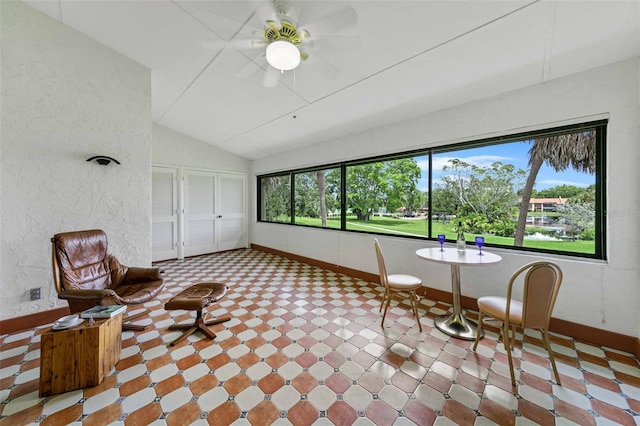 unfurnished sunroom featuring ceiling fan and vaulted ceiling