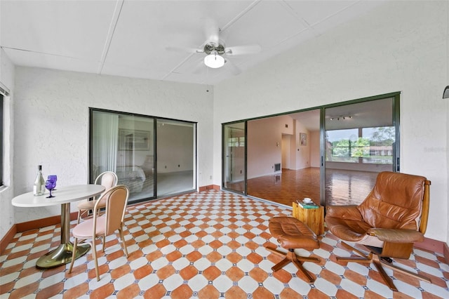 interior space with tile patterned flooring and ceiling fan