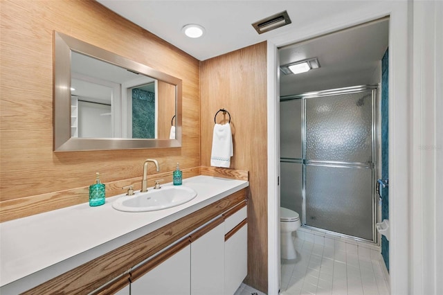 bathroom with vanity, toilet, and tile patterned floors