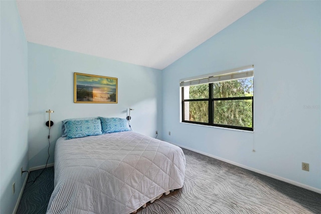 carpeted bedroom with lofted ceiling