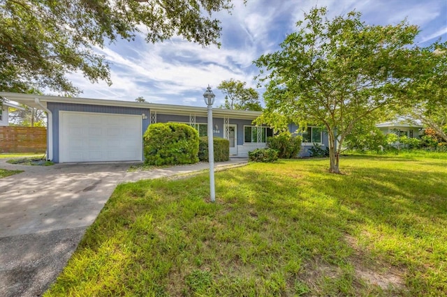 ranch-style house with a garage and a front lawn