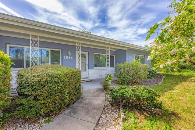 view of exterior entry with covered porch