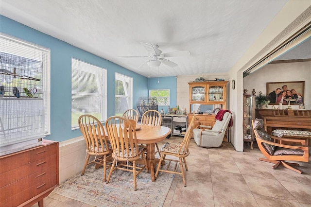 tiled dining area featuring ceiling fan