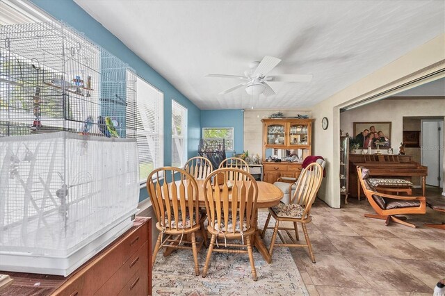 dining room with light tile patterned flooring and ceiling fan