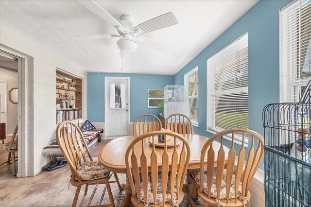 tiled dining space with ceiling fan