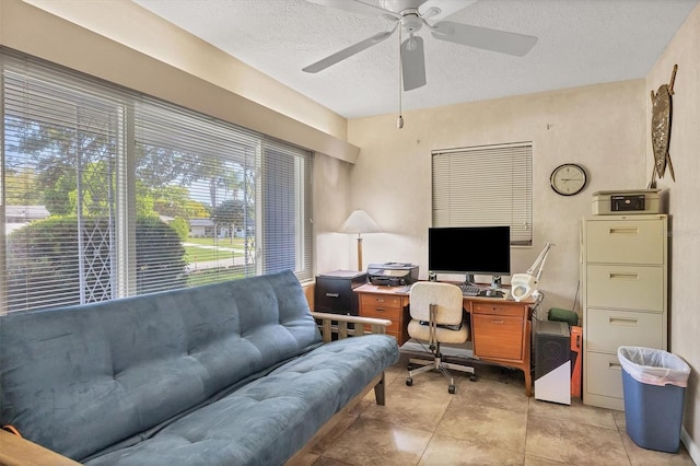 office space with light tile patterned flooring, a textured ceiling, and ceiling fan