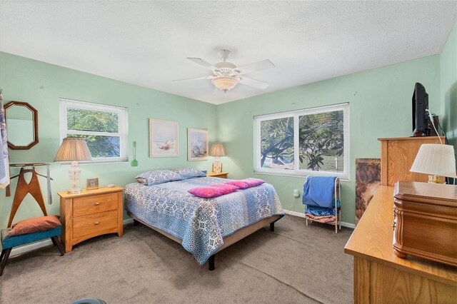 bedroom with carpet flooring, a textured ceiling, and ceiling fan