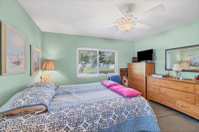 carpeted bedroom with a textured ceiling and ceiling fan