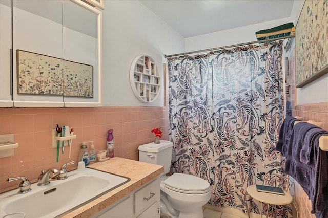 bathroom with vanity, decorative backsplash, tile walls, and toilet