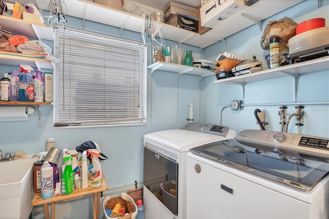 clothes washing area with sink and washer and dryer