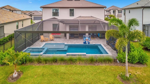 rear view of property with a lanai, a yard, a pool with hot tub, and a patio area