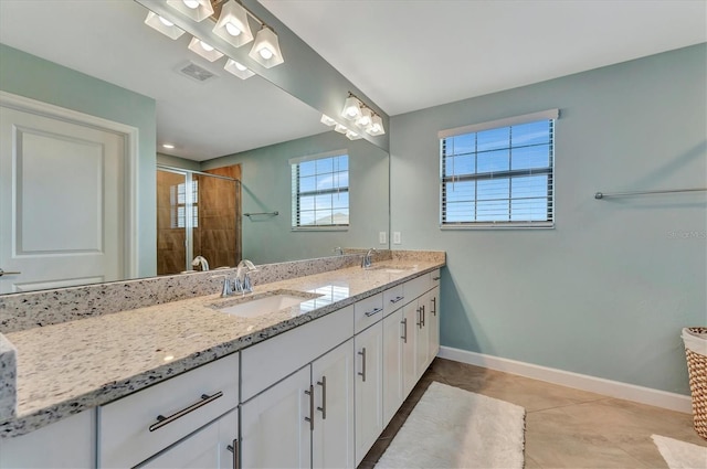 bathroom featuring tile patterned floors, vanity, and a shower with shower door