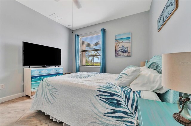 tiled bedroom featuring ceiling fan