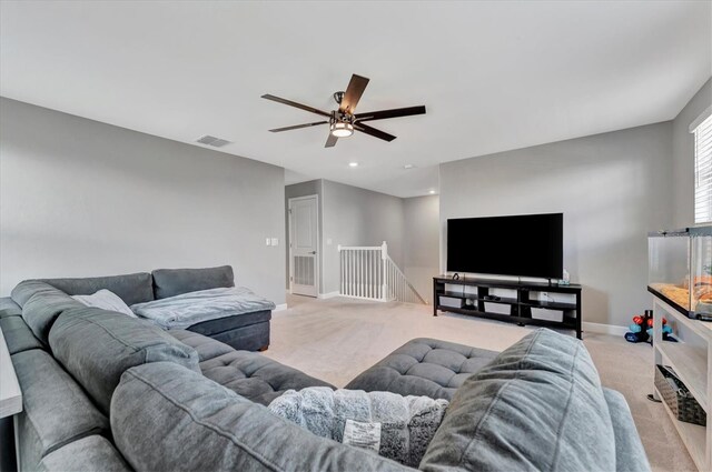 carpeted living room with ceiling fan