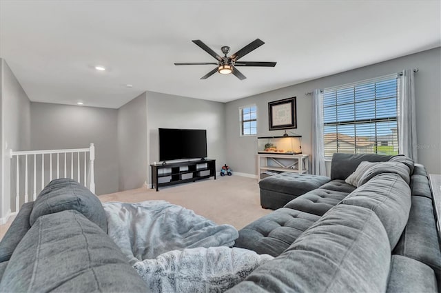 carpeted living room featuring ceiling fan