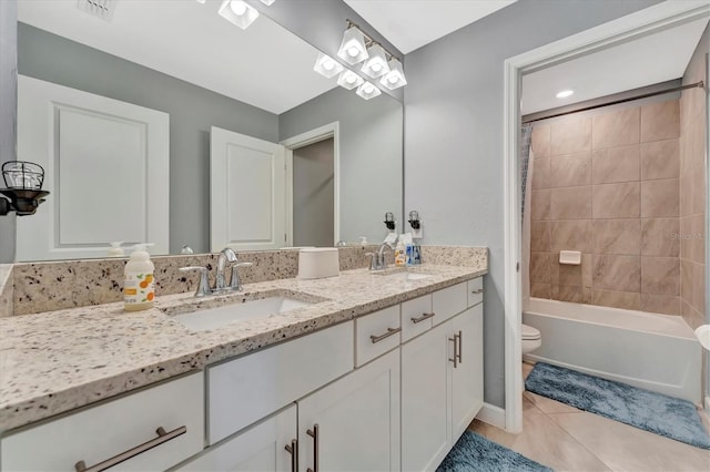 full bathroom featuring vanity, tile patterned floors, toilet, and tiled shower / bath