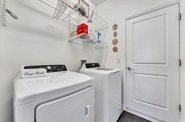 clothes washing area with washer and dryer