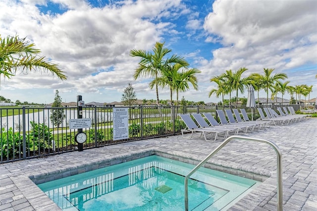 view of swimming pool featuring a community hot tub and a patio area