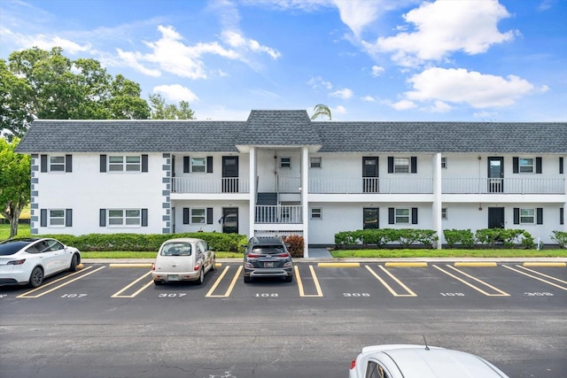 view of building exterior featuring uncovered parking