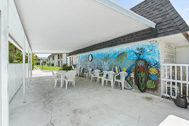 view of patio featuring outdoor dining space and fence