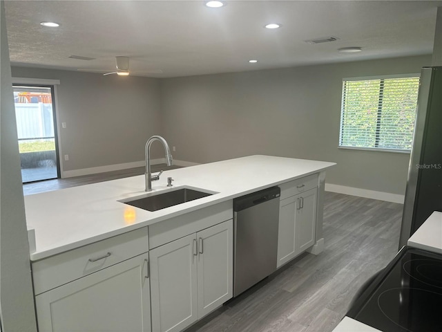 kitchen featuring hardwood / wood-style floors, stainless steel appliances, ceiling fan, and a healthy amount of sunlight