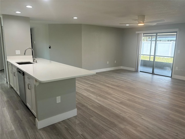 kitchen with hardwood / wood-style floors, dishwasher, white cabinets, ceiling fan, and sink