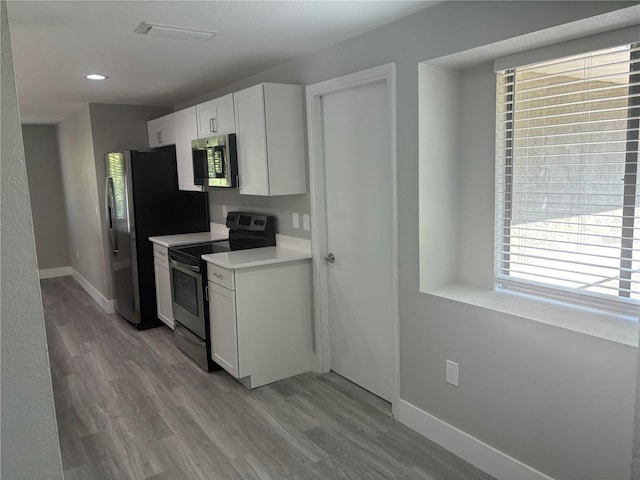 kitchen featuring white cabinetry, stainless steel appliances, and light hardwood / wood-style floors