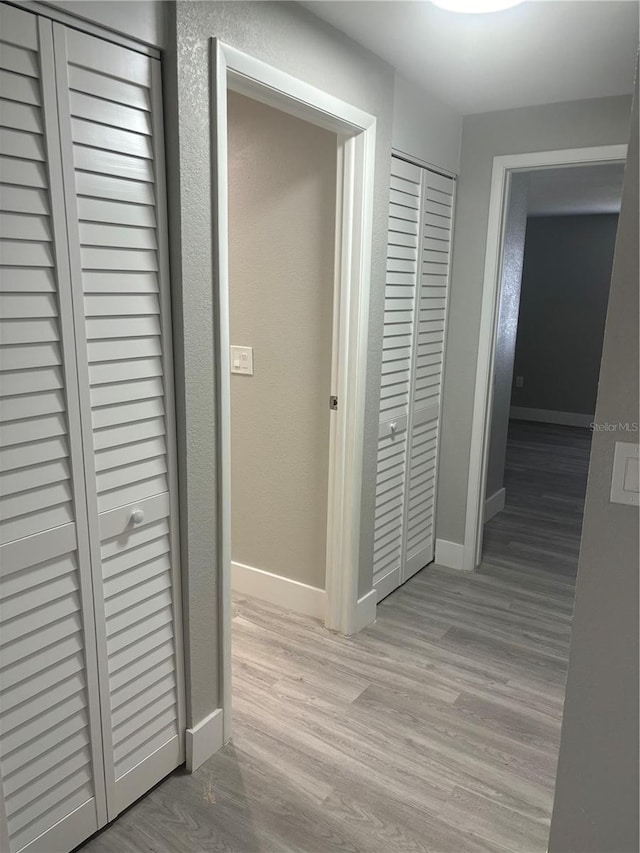 hallway with hardwood / wood-style floors