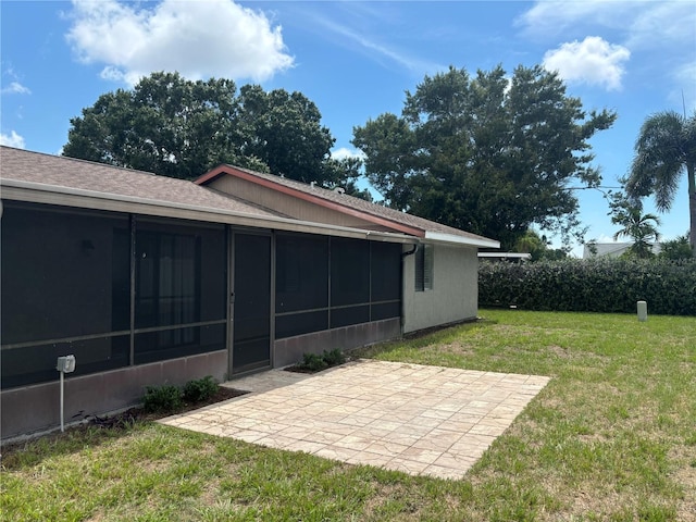 view of yard featuring a patio and a sunroom